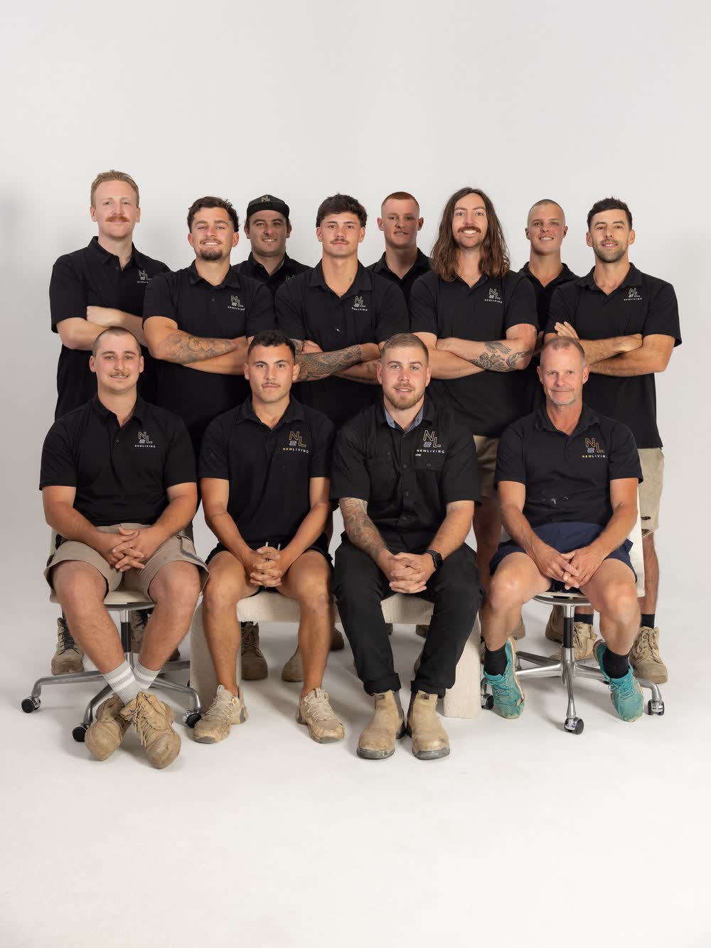The New Living crew in branded polos, seated and standing